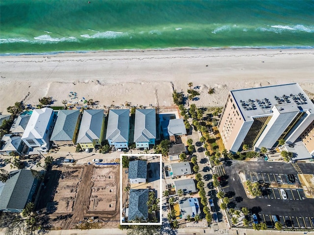 birds eye view of property featuring a beach view and a water view