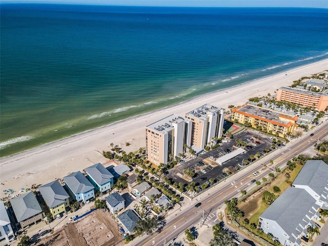 drone / aerial view featuring a water view and a beach view