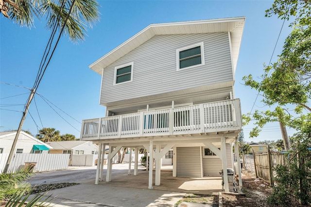 back of house featuring a carport