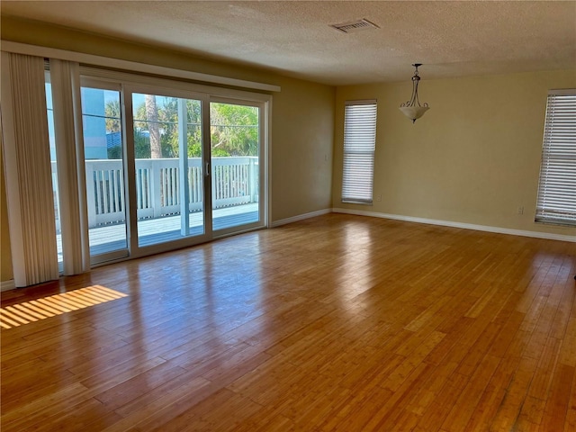 empty room featuring light hardwood / wood-style floors and a textured ceiling