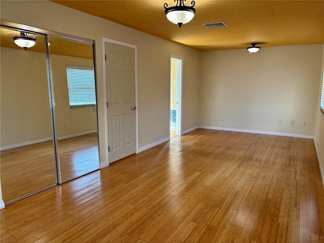 interior space featuring a textured ceiling and light wood-type flooring