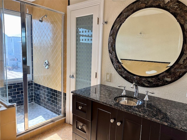 bathroom featuring tile patterned flooring, vanity, and walk in shower