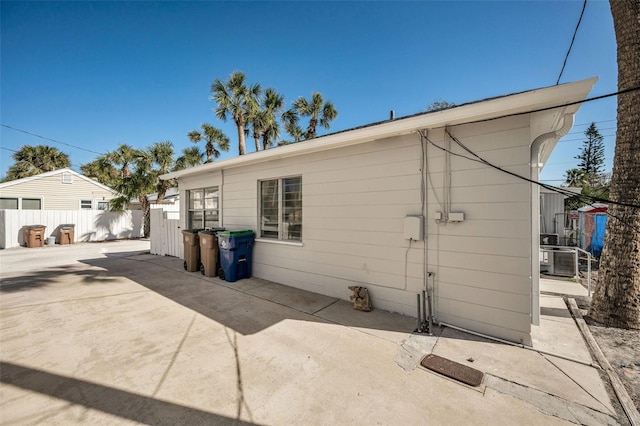 view of side of property featuring a patio and central AC