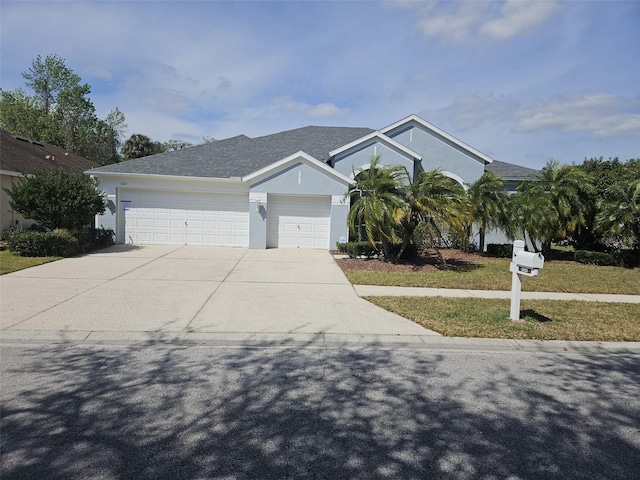 view of front of home with a front lawn and a garage