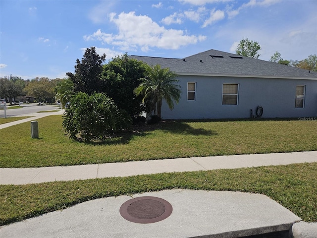 view of property exterior with a lawn