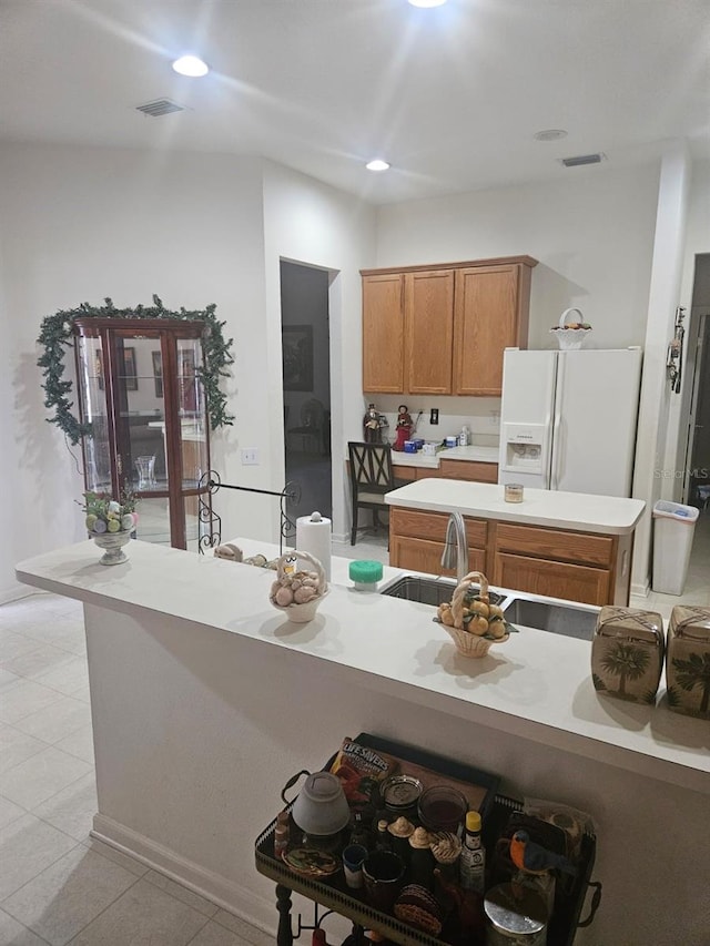 kitchen featuring white fridge with ice dispenser