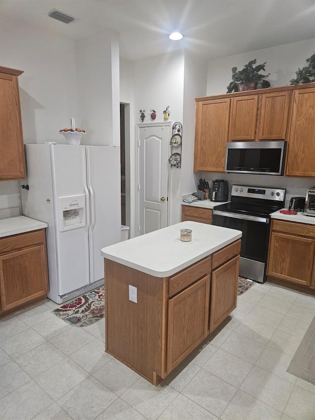 kitchen with a kitchen island and appliances with stainless steel finishes