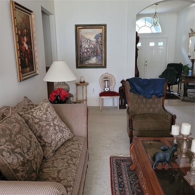 living room with carpet flooring and a notable chandelier