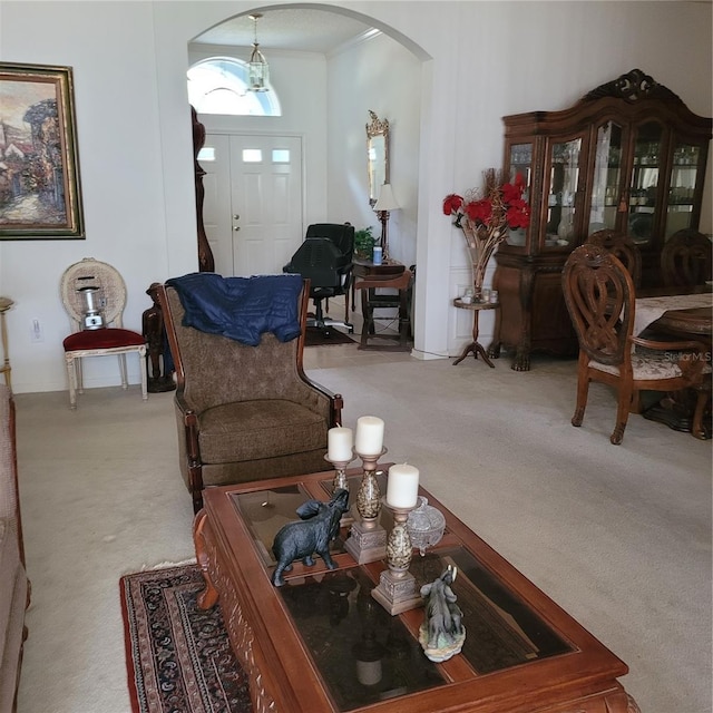 carpeted living room with crown molding