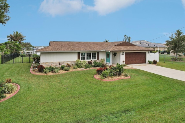 ranch-style house featuring a garage and a front lawn