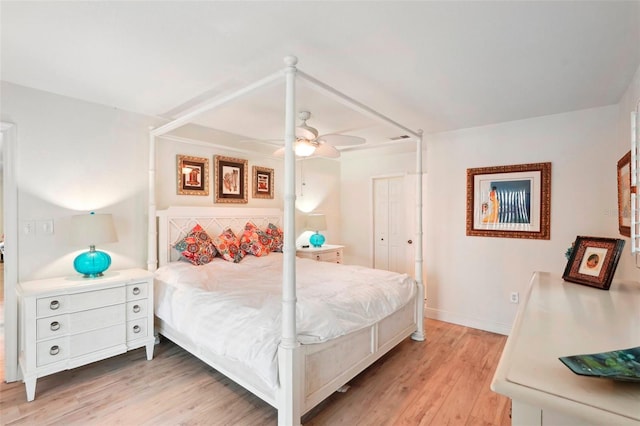 bedroom featuring ceiling fan, light wood-type flooring, and a closet