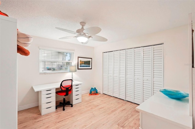 office area with a textured ceiling, light hardwood / wood-style flooring, and ceiling fan