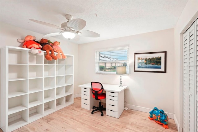 office area featuring ceiling fan, a textured ceiling, and light hardwood / wood-style flooring