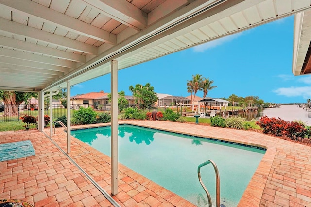 view of swimming pool featuring a water view and a patio area