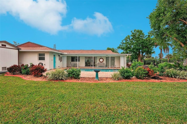 back of house featuring a lawn and a patio area