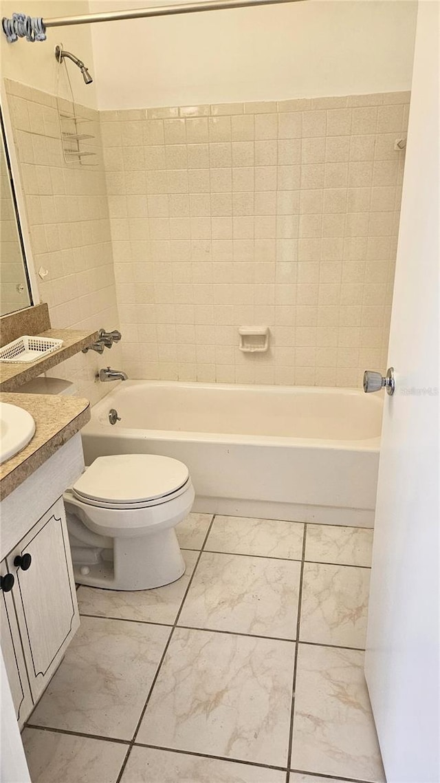 full bathroom with vanity, toilet, and tiled shower / bath