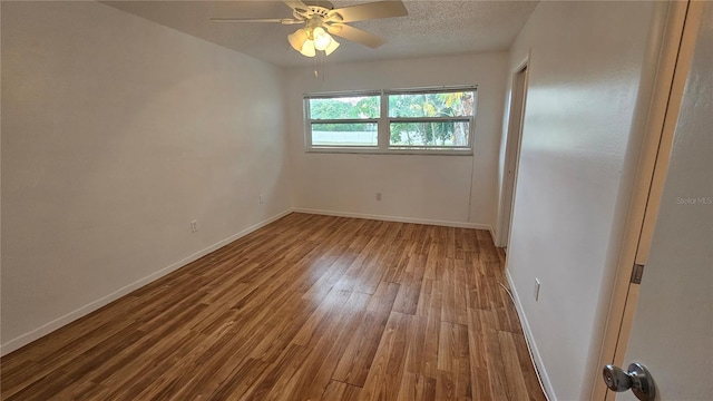 unfurnished room featuring hardwood / wood-style flooring, ceiling fan, and a textured ceiling