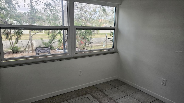 unfurnished room with tile patterned floors