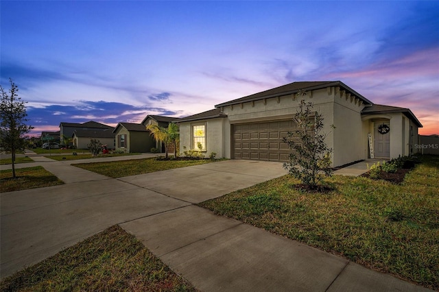 single story home featuring a yard and a garage