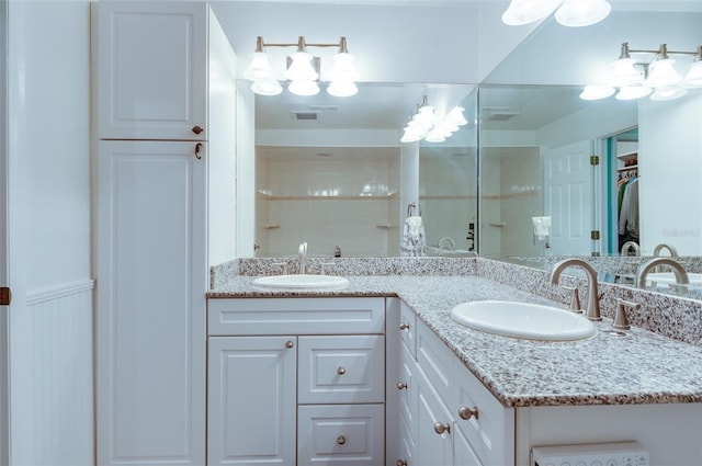 bathroom with a shower and vanity