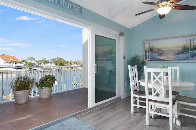 balcony with a water view and ceiling fan