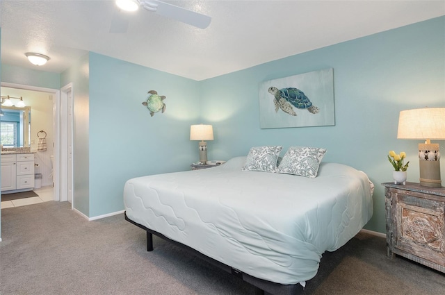 bedroom featuring light colored carpet, ceiling fan, and ensuite bathroom