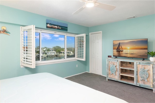 bedroom with carpet, a closet, and ceiling fan