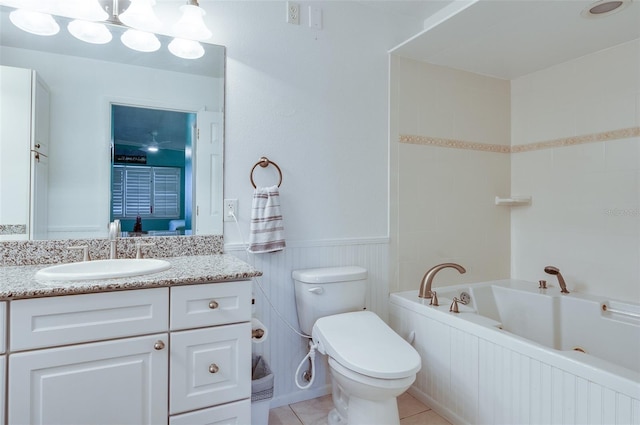 bathroom featuring tile patterned floors, a tub, vanity, and toilet