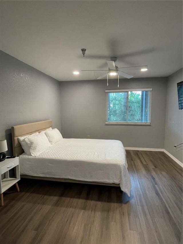 bedroom with ceiling fan and hardwood / wood-style flooring