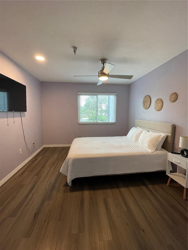 bedroom featuring ceiling fan and dark wood-type flooring