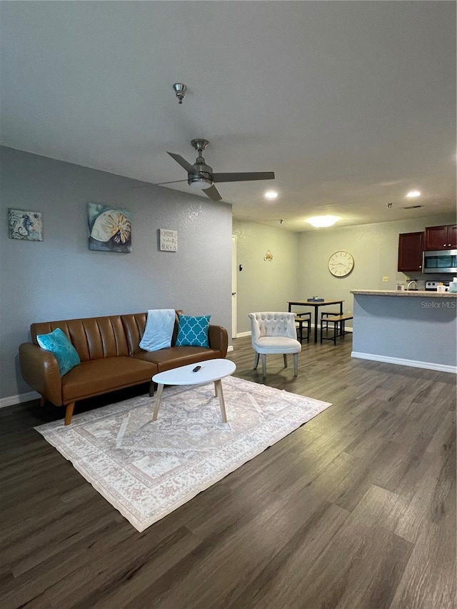 living room featuring dark hardwood / wood-style floors and ceiling fan