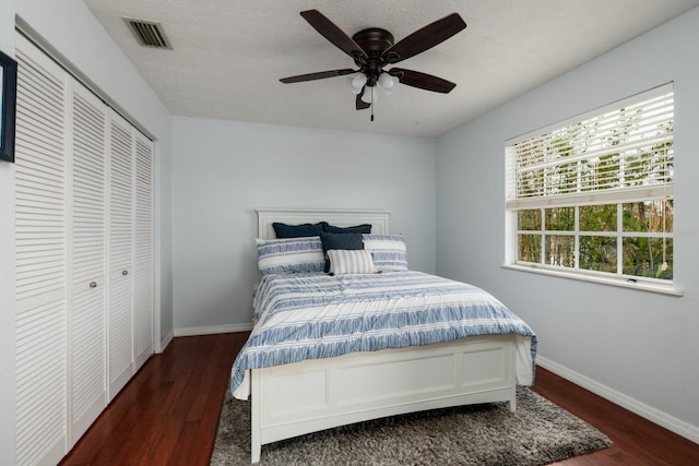 bedroom featuring ceiling fan, a closet, and dark hardwood / wood-style floors