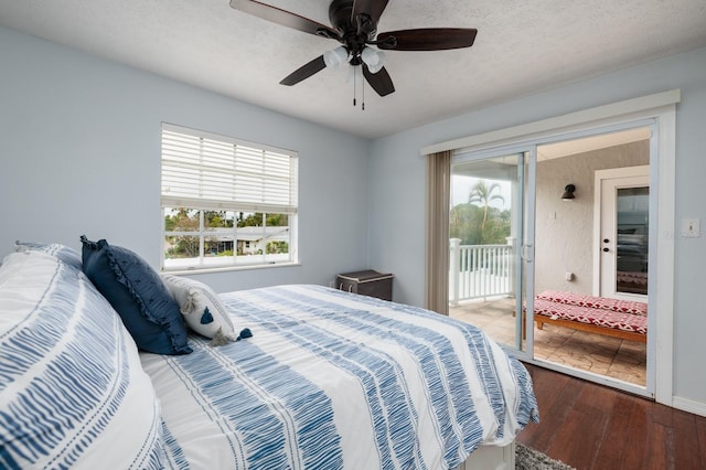 bedroom featuring multiple windows, hardwood / wood-style floors, access to outside, and ceiling fan