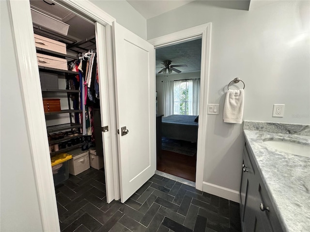 bathroom featuring vanity and ceiling fan