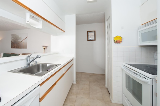 kitchen with white cabinets, white appliances, and sink