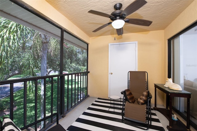 sunroom featuring ceiling fan