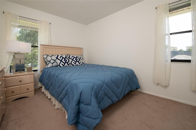 carpeted bedroom with a textured ceiling