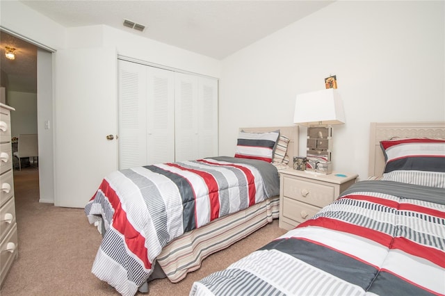 carpeted bedroom with a closet