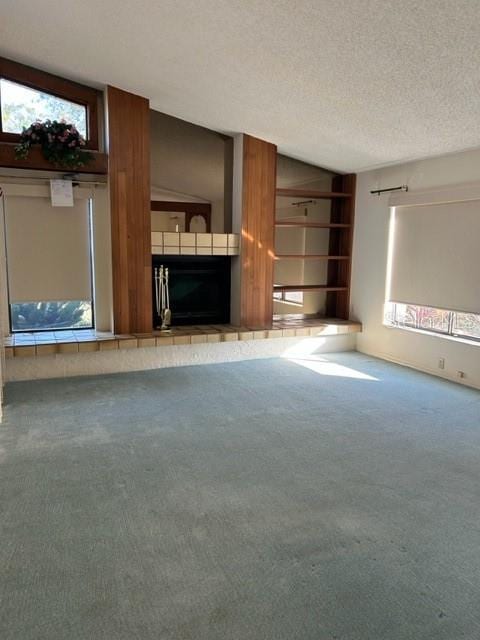 unfurnished living room featuring carpet flooring and a textured ceiling