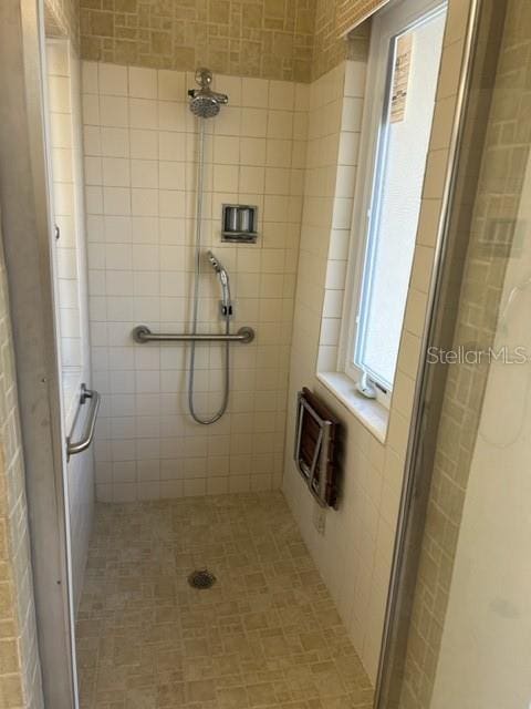 bathroom featuring heating unit and walk in shower