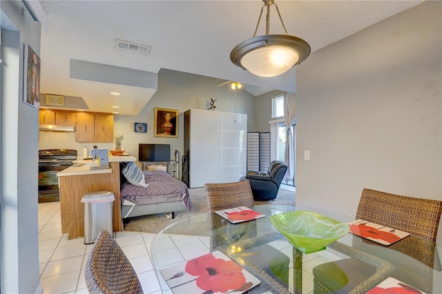 tiled dining room with lofted ceiling