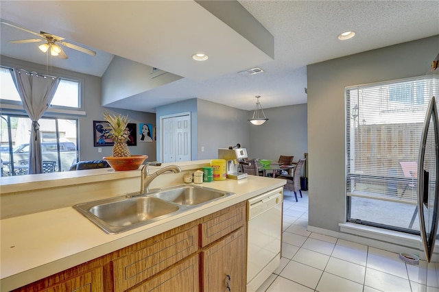 kitchen featuring white dishwasher, sink, ceiling fan, a textured ceiling, and light tile patterned flooring