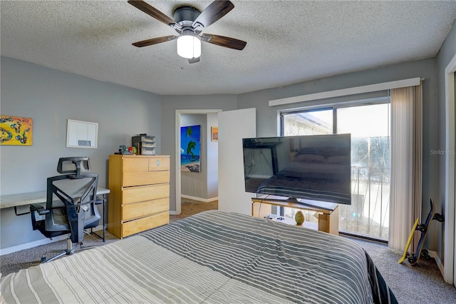 carpeted bedroom with a textured ceiling and ceiling fan