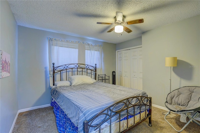 carpeted bedroom with ceiling fan, a textured ceiling, and a closet