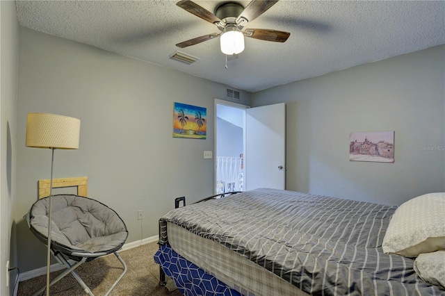 bedroom featuring carpet flooring, ceiling fan, and a textured ceiling