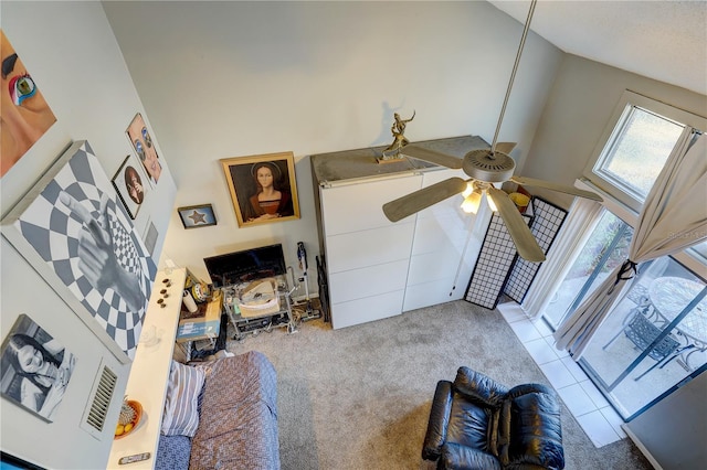 living room featuring ceiling fan, light colored carpet, and high vaulted ceiling