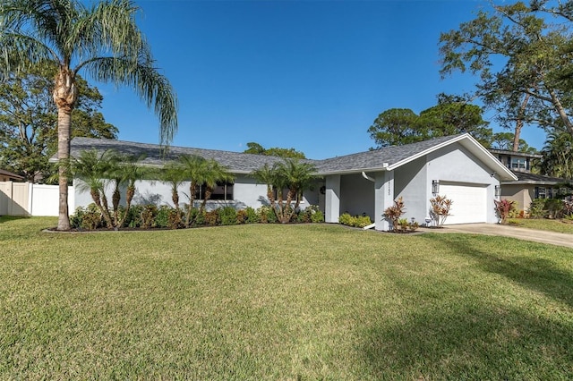 ranch-style house featuring a front yard and a garage