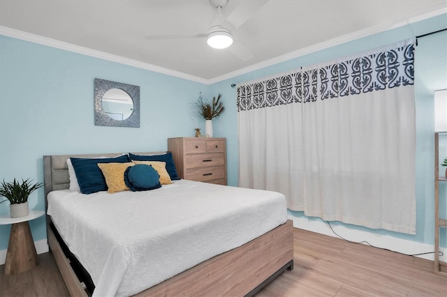 bedroom with wood-type flooring, ceiling fan, and crown molding