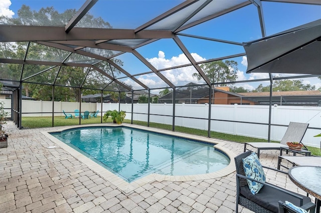 view of swimming pool with a lanai and a patio