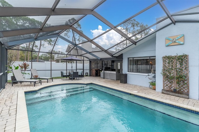 view of swimming pool with a lanai, an outdoor living space, and a patio area